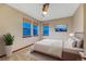 This bedroom features a plush bed, windows with blinds, and a ceiling fan at 10459 Rivington Ct, Lone Tree, CO 80124