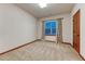 Spacious bedroom features neutral carpet, paint and trim, and large window at 10459 Rivington Ct, Lone Tree, CO 80124