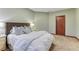 Comfortable bedroom showcasing a bed with soft bedding and wooden trim at 10459 Rivington Ct, Lone Tree, CO 80124