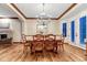 Elegant dining room featuring a modern chandelier, hardwood floors, and bright natural light at 10459 Rivington Ct, Lone Tree, CO 80124