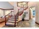 Elegant foyer with a grand staircase, slate floors, and stylish architectural details at 10459 Rivington Ct, Lone Tree, CO 80124