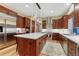 Spacious kitchen boasts a large island with a marble countertop and stainless steel appliances at 10459 Rivington Ct, Lone Tree, CO 80124
