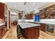 Gourmet kitchen with an island featuring marble countertops, wooden cabinets, and stainless steel appliances at 10459 Rivington Ct, Lone Tree, CO 80124