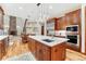 Open kitchen features a central island with a marble countertop, stainless steel appliances, and hardwood flooring at 10459 Rivington Ct, Lone Tree, CO 80124