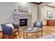 Inviting living room with a stone fireplace, hardwood floors, and stylish decor at 10459 Rivington Ct, Lone Tree, CO 80124