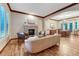 Cozy living room with a stone fireplace, hardwood floors, and comfortable seating area at 10459 Rivington Ct, Lone Tree, CO 80124