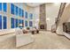 Bright living room with large windows, a stone fireplace, and a staircase at 10459 Rivington Ct, Lone Tree, CO 80124