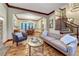 Bright and open living room with view to dining area, hardwood floors, and a staircase at 10459 Rivington Ct, Lone Tree, CO 80124