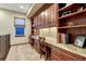 Functional home office space with granite countertops, custom cabinets, and built-in bookshelves at 10459 Rivington Ct, Lone Tree, CO 80124