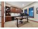 Well-lit home office featuring custom built-in cabinets and shelving, with ample workspace at 10459 Rivington Ct, Lone Tree, CO 80124