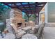 Picturesque outdoor space showcasing a stone fireplace, built-in grill, and cozy seating for enjoying evenings outdoors at 10459 Rivington Ct, Lone Tree, CO 80124