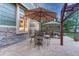 Charming outdoor patio featuring dining sets with umbrellas, stone accents, and garden views at 10459 Rivington Ct, Lone Tree, CO 80124