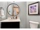 Contemporary powder room features a round mirror, black vanity, and stylish accents at 10459 Rivington Ct, Lone Tree, CO 80124