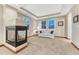 Cozy sitting area with fireplace, neutral decor, and bright windows at 10459 Rivington Ct, Lone Tree, CO 80124
