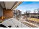Balcony overlooking well-maintained green spaces with mature trees, sitting areas, and pathways for relaxing outdoor enjoyment at 955 Eudora St # 307E, Denver, CO 80220