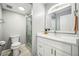 White bathroom features a walk-in shower, plush grey carpets and a modern vanity with white marble counter at 955 Eudora St # 307E, Denver, CO 80220
