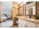 Bathroom featuring granite countertops, double vanity, framed mirrors and modern lighting at 955 Eudora St # 307E, Denver, CO 80220