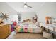 Bedroom featuring a ceiling fan, plush carpets, a built in bookshelf and a large window at 955 Eudora St # 307E, Denver, CO 80220