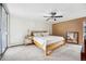 Bright bedroom with a modern ceiling fan, complemented by neutral carpet and a sliding glass door for lots of natural light at 955 Eudora St # 307E, Denver, CO 80220