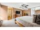 Bedroom features a modern ceiling fan, neutral colored walls, and access to an en-suite bathroom and balcony at 955 Eudora St # 307E, Denver, CO 80220
