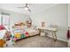 Bright bedroom featuring a ceiling fan, plush carpets, and a built in bookshelf at 955 Eudora St # 307E, Denver, CO 80220