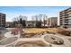 Well-maintained common area featuring a pergola, manicured landscaping, and multiple seating areas for residents to enjoy at 955 Eudora St # 307E, Denver, CO 80220