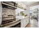 Updated kitchen with stainless steel appliances, marble counters, mosaic backsplash, and open layout at 955 Eudora St # 307E, Denver, CO 80220