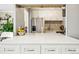 Kitchen featuring white cabinets, marble countertop, and stainless-steel appliances at 955 Eudora St # 307E, Denver, CO 80220