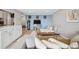 Bright living room featuring hard wood floors, stylish decor, and a seamless flow into the kitchen at 955 Eudora St # 307E, Denver, CO 80220