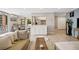 Open-concept living room with hardwood floors, light gray walls, and access to a dining area at 955 Eudora St # 307E, Denver, CO 80220