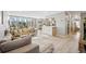 Bright living room with large windows, hardwood floors, and an open floor plan to the dining area at 955 Eudora St # 307E, Denver, CO 80220