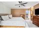 Well-lit main bedroom with soft carpet, complemented by warm-toned walls, designer fan and en suite bath for added convenience at 955 Eudora St # 307E, Denver, CO 80220