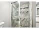 Updated shower featuring decorative tile with a glass door, showcasing modern bathroom design at 955 Eudora St # 307E, Denver, CO 80220