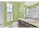 Fresh green bathroom with a glass-enclosed shower and modern fixtures at 8065 E 21St Ave, Denver, CO 80238