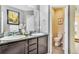 Chic bathroom with double sinks, granite counters, and a separate toilet room for added privacy and convenience at 8065 E 21St Ave, Denver, CO 80238