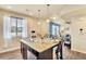 Kitchen island featuring a stainless steel sink, granite countertop, and views into the bright living area at 8065 E 21St Ave, Denver, CO 80238