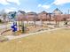 Community playground featuring a slide, swings, and lush green surroundings at 8065 E 21St Ave, Denver, CO 80238