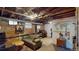 Unfinished basement with exposed brick walls, wooden beams and concrete flooring at 126 S Clarkson St, Denver, CO 80209