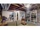 Open basement area featuring exposed brick, ductwork, and built-in shelving for storage at 126 S Clarkson St, Denver, CO 80209