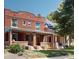 Charming brick duplex with covered front porch and lush landscaping at 126 S Clarkson St, Denver, CO 80209