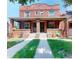 Charming brick duplex with a shared front porch and well-maintained lawn at 126 S Clarkson St, Denver, CO 80209