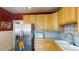 Kitchen featuring stainless steel appliances, and wood cabinetry at 126 S Clarkson St, Denver, CO 80209