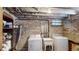 Basement laundry area with a modern washer and dryer, as well as a utility sink at 126 S Clarkson St, Denver, CO 80209