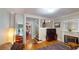Bright living room featuring hardwood floors, fireplace, and open staircase at 126 S Clarkson St, Denver, CO 80209