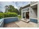 Back patio with sliding door access to the house and view of the green backyard at 1419 Red Mountain Dr # 126, Longmont, CO 80504
