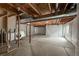 Unfinished basement with laundry area, exposed beams, and concrete flooring at 1419 Red Mountain Dr # 126, Longmont, CO 80504