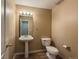Cozy half-bath features neutral tones, a pedestal sink, and a classic toilet, perfect for guests at 1419 Red Mountain Dr # 126, Longmont, CO 80504