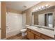 Functional bathroom featuring a combined tub and shower, a vanity with ample lighting, and neutral tile at 1419 Red Mountain Dr # 126, Longmont, CO 80504