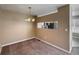 Traditional dining room featuring tan walls and carpet, an elegant chandelier, and a pass-through window to the kitchen at 1419 Red Mountain Dr # 126, Longmont, CO 80504