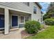 Close-up of unit exterior with blue door and well-manicured landscaping and stone ground cover at 1419 Red Mountain Dr # 126, Longmont, CO 80504